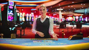 Mobile phone displaying a live blackjack table with a dealer visible on screen